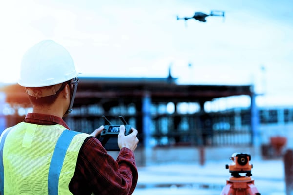 drone pilot flying at construction site